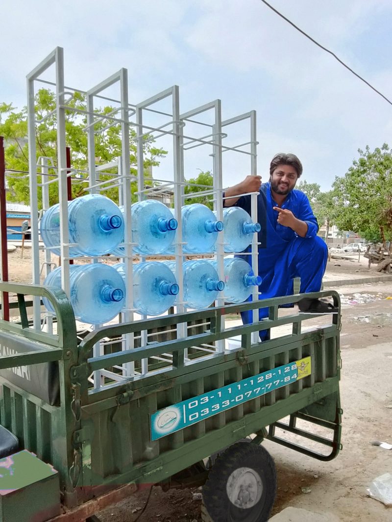 A Cyan Bay team member with a loaded rack of 19 litre bottles